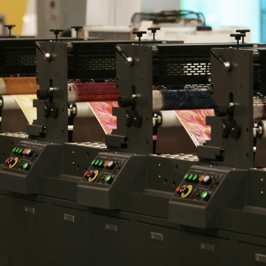 A line of printing presses working simultaneously alongside in time series