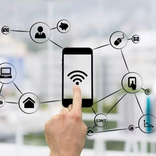Finger touching drawing of smart phone with wifi sign and connections to other digital tokens