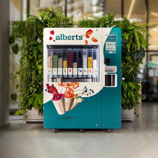 Alberts smart product smoothie vending machine in hallway in front of green plants against wall