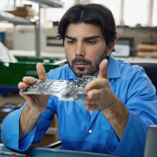 man-worker-is-wearing-blue-shirt-holding-motherboard-his-hands