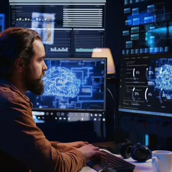 Freelance programmer using computer interacting with artificial intelligence