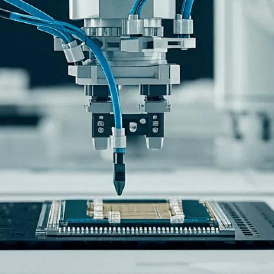 Robotic arm placing a chip on a circuit board