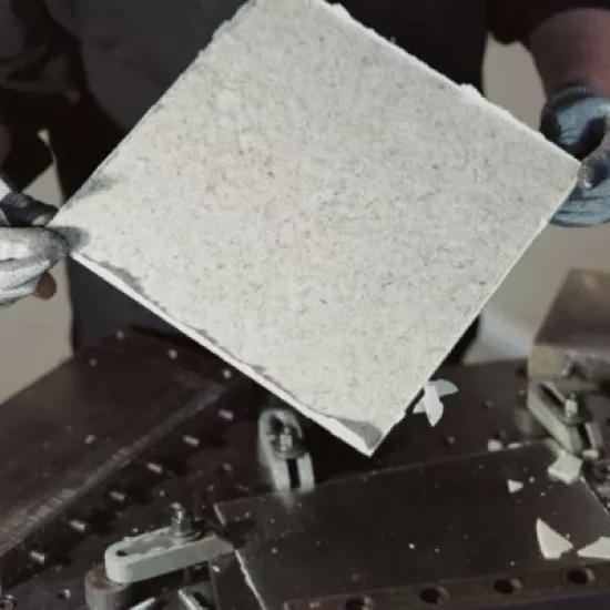 Someone holding a piece of composite material.