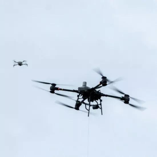 Drones flying in through the sky 