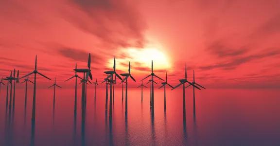Offshore windmolens tegen zonsondergang