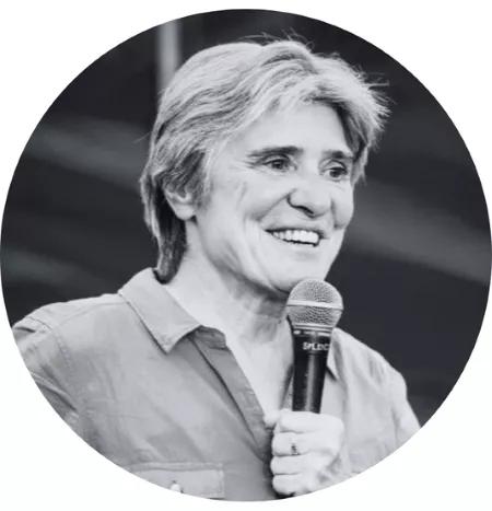Karine Van Doorsselaer holding a mic while presenting