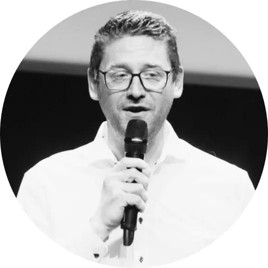 Olivier Whatelet holding a mic while presenting