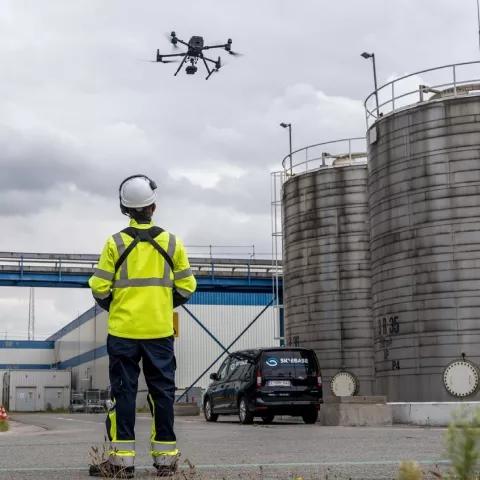 Skyebase employee flying with drone in harbour.