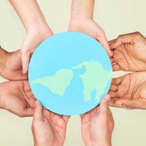 Sustainability several hands holding flat globe on kight green background