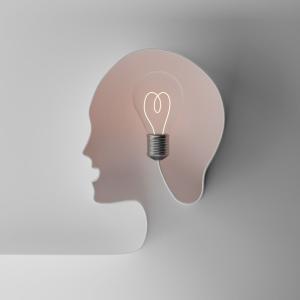Human head simulated with cord on light bulb illustrating creative idea and intellectual property
