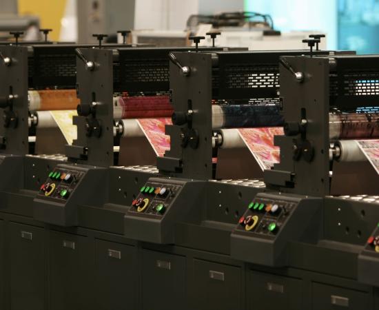 A line of printing presses working simultaneously alongside in time series
