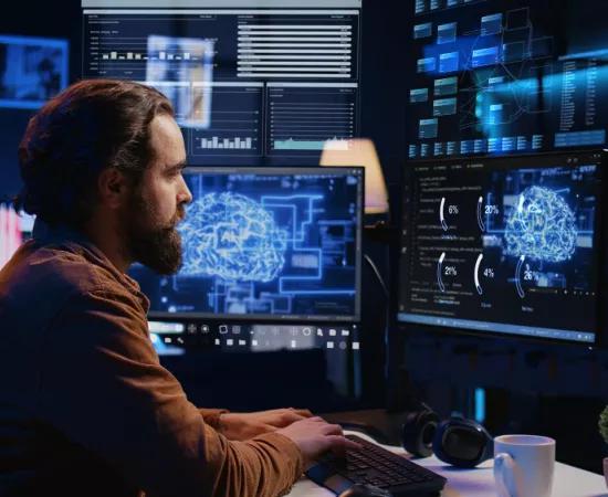 Freelance programmer using computer interacting with artificial intelligence